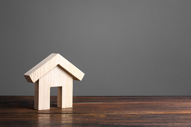 Wooden house figure. Modern architecture. Mortgage. Affordable comfortable housing. Purchase of apartments and real estate, rent and sale. Housing, new home. Urban Studies and Planning. Copy Space